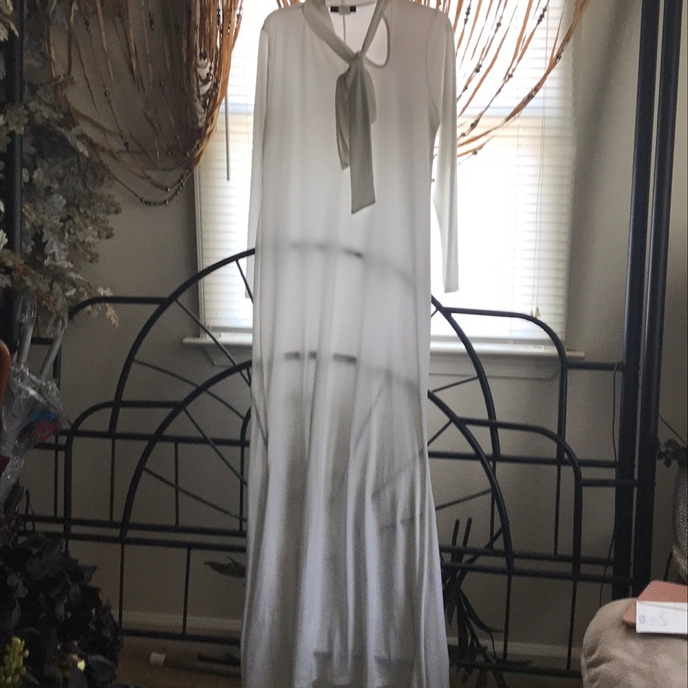 White dress with tie on neck.
